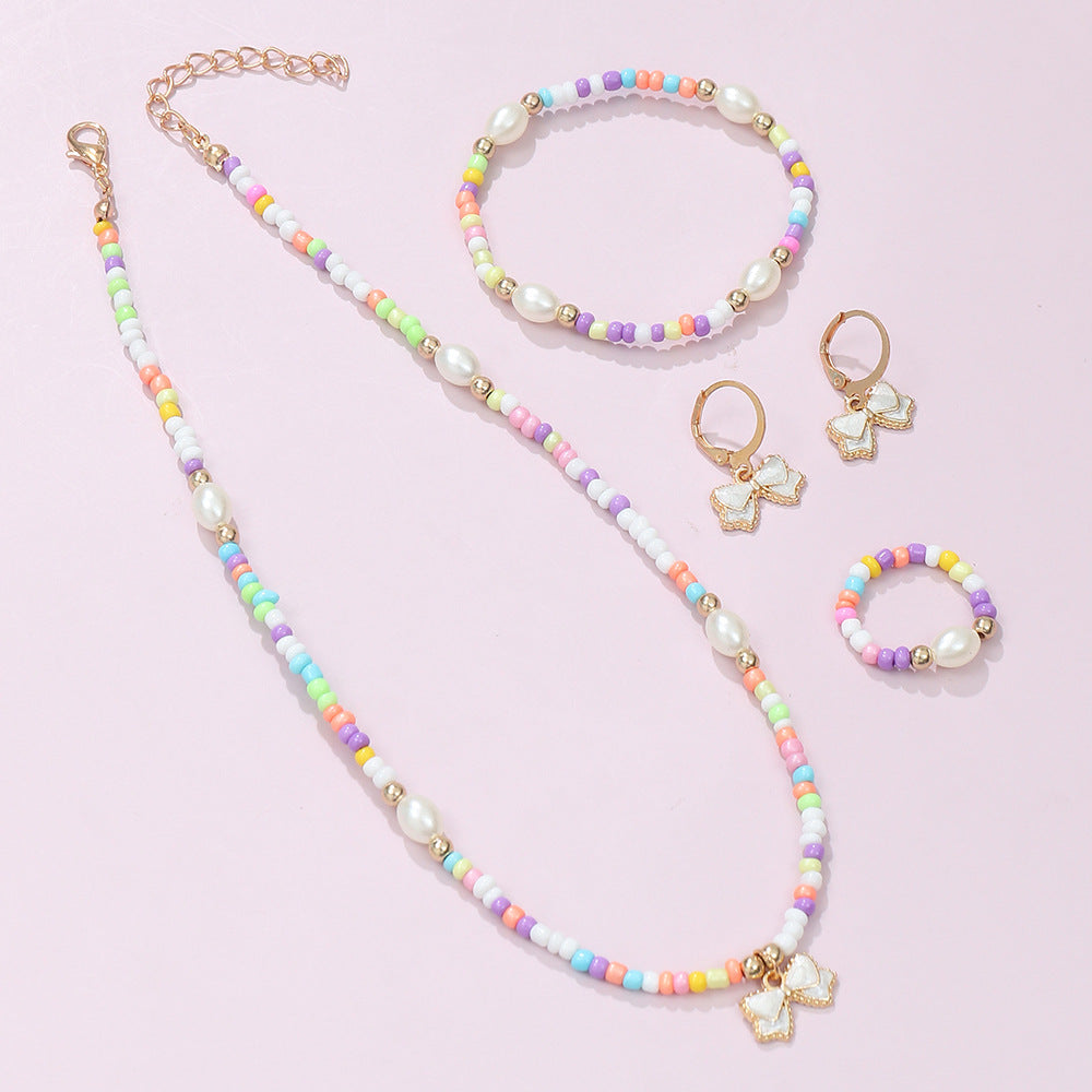 Conjunto de collar, pulsera, anillo y pendientes de aleación con forma de lazo estilo bohemio con acabado esmaltado para niños