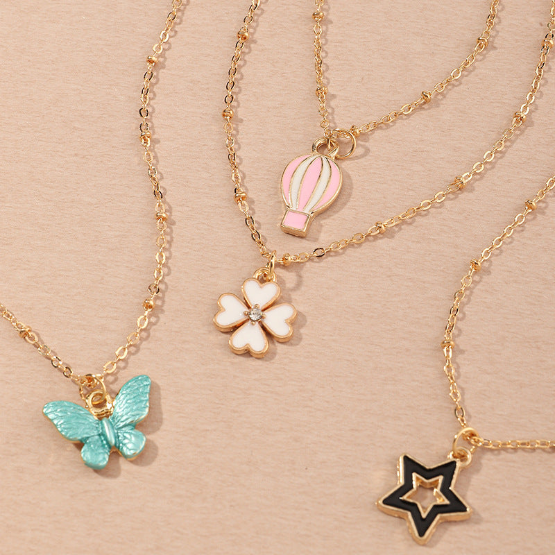 Set Collana per Bambini con Ciondoli a Cartone Animato Farfalla Stella Quadrifoglio Mongolfiera in Lega Smalto con Catena a Scatola