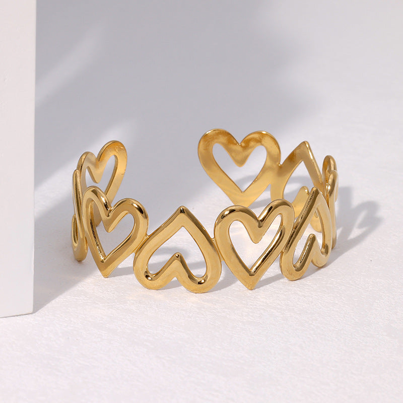 Bracciale rigido in acciaio inossidabile placcato oro a forma di cuore, minimalista e delicato, con finitura liscia e lucida