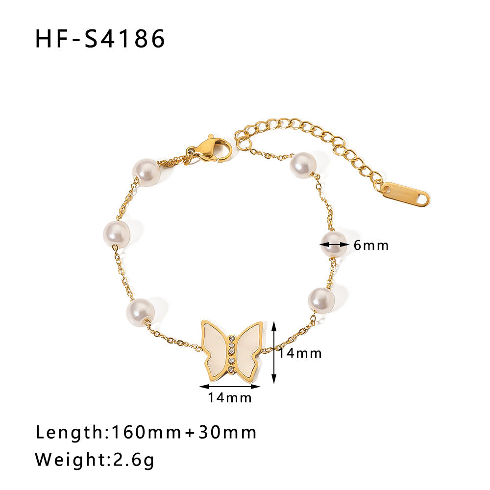 Bracciale vintage con farfalla e ciondolo rotondo in acciaio inossidabile con intarsio di strass e dettagli in perle
