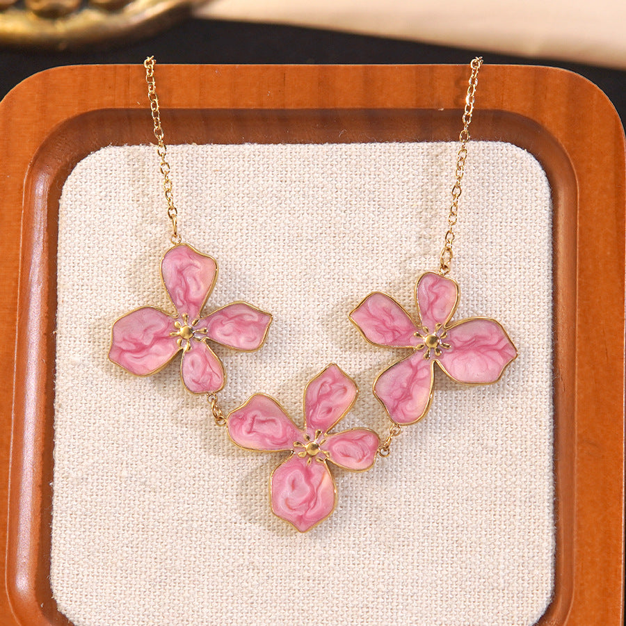 Elegante set collana e orecchini da donna in acciaio inossidabile con motivo floreale a goccia d'olio per affari