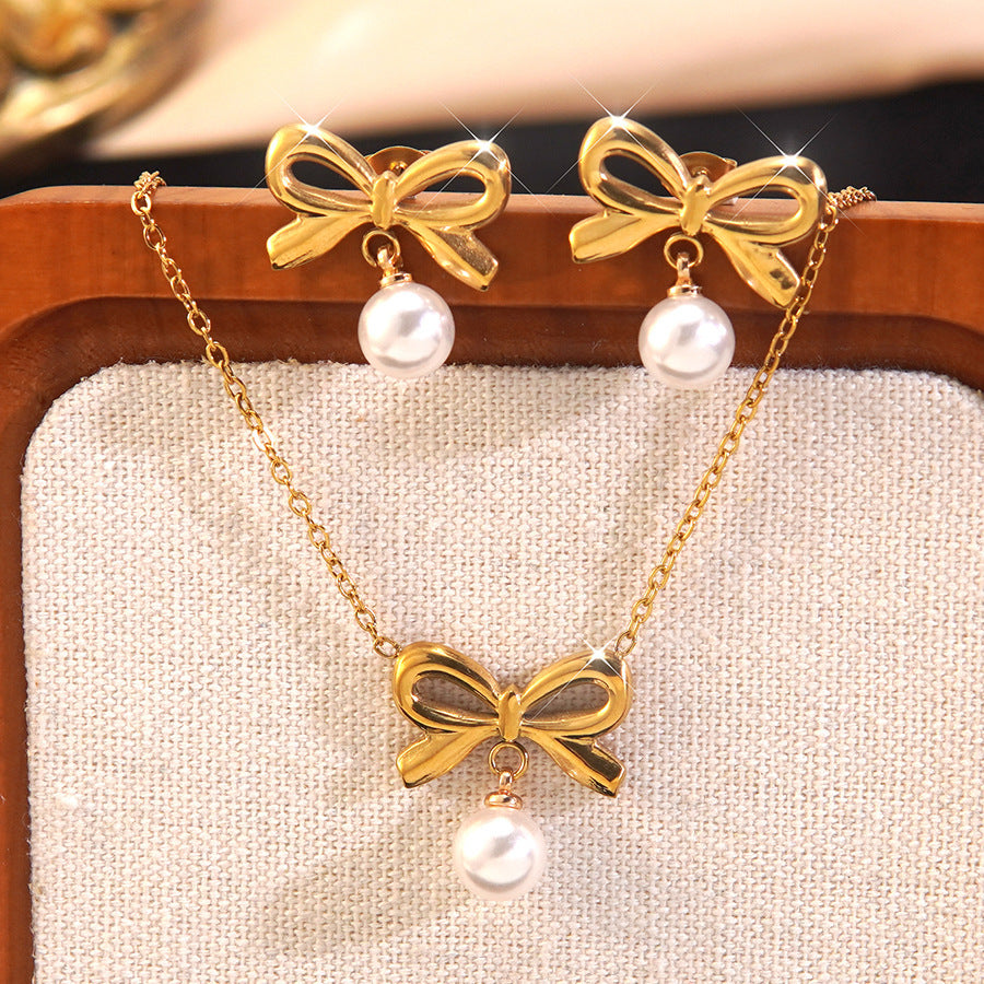 Elegante parure collana e orecchini in acciaio inossidabile con fiocco e perle, con catena a maglie forzatine