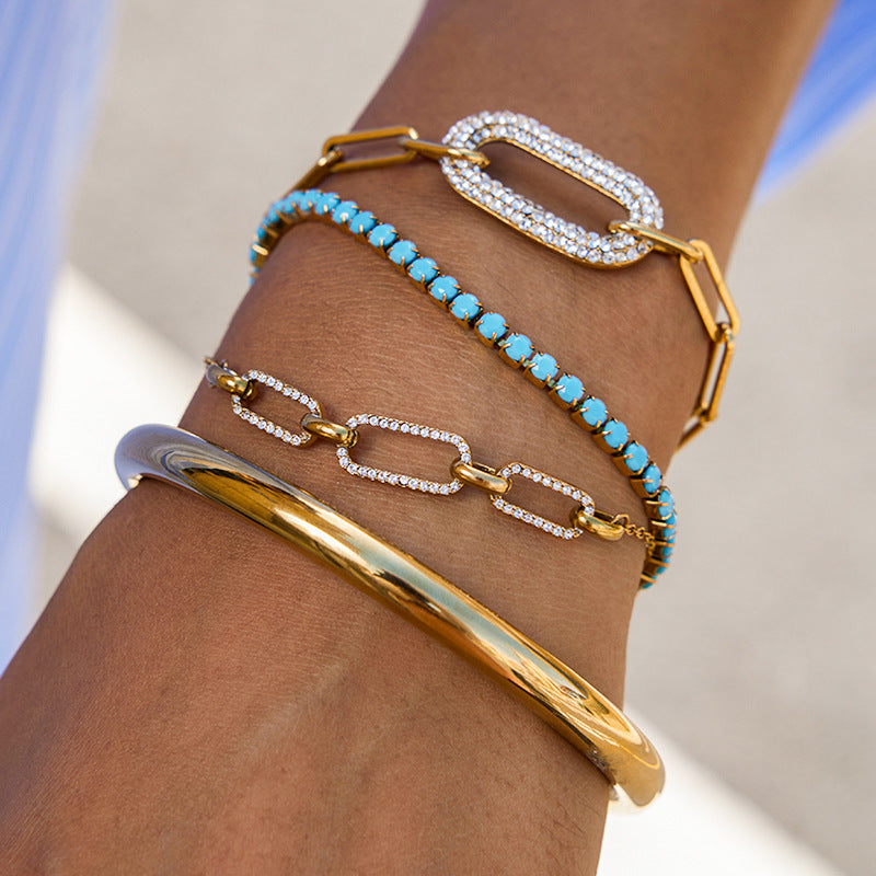 Pulsera geométrica de acero inoxidable chapado con circonita blanca y turquesa para mujer. Joyería minimalista de lujo.
