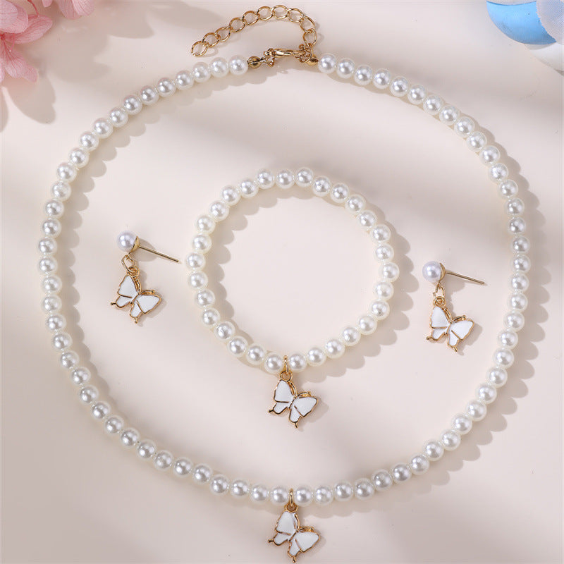 Conjunto Minimalista de Collar con Forma de Lazo de Aleación para Niñas con Detalles de Perlas, Incluye Pulsera, Anillo y Pendientes de Botón