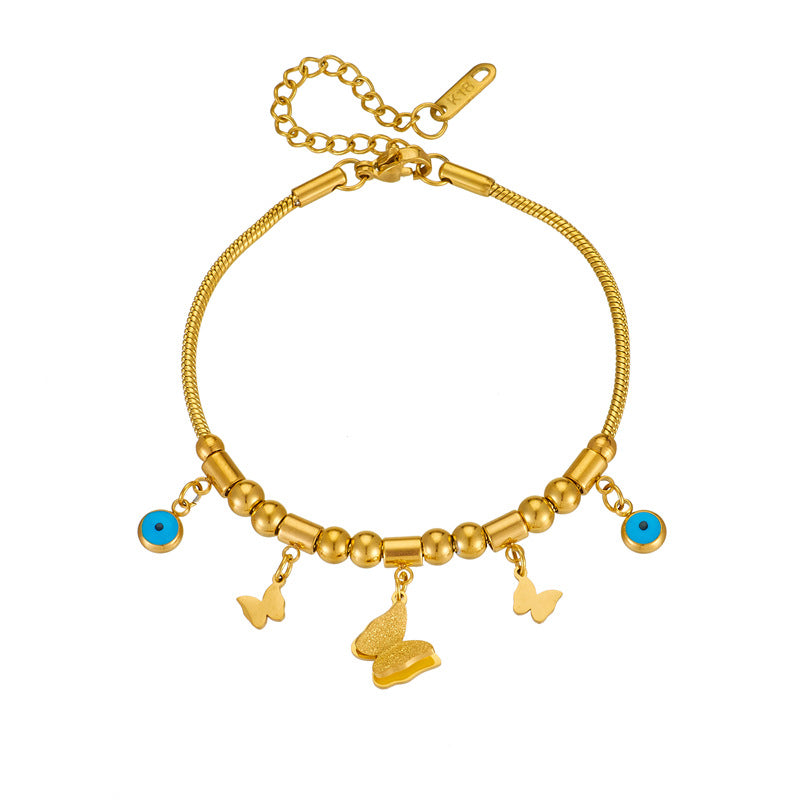 Elegante bracciale con ciondolo a farfalla in acciaio al titanio, perline geometriche e occhi smaltati blu per donna