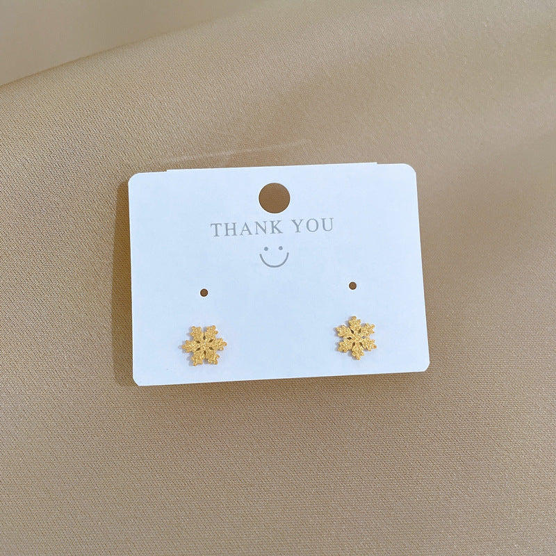 Orecchini a fiocco di neve geometrici minimalisti in titanio e acciaio per donna con finitura in lamina d'oro, ideali per eventi formali e l'uso quotidiano