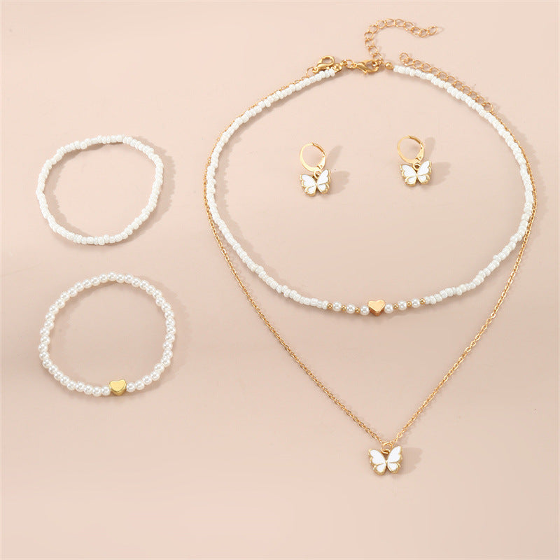 Set collana con ciondolo a farfalla fatto a mano per bambini con perline bianche e ciondolo in lega in stile fresco