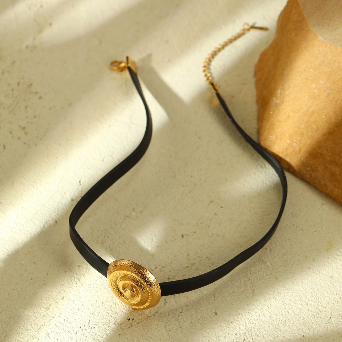 Collar minimalista de acero de titanio en forma de lazo para mujer con acabado chapado y detalle de cuero