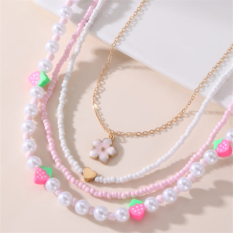 Collar con colgante de lazo y mariposa minimalista para niños, fabricado en resina con acabado esmaltado en tono rosa