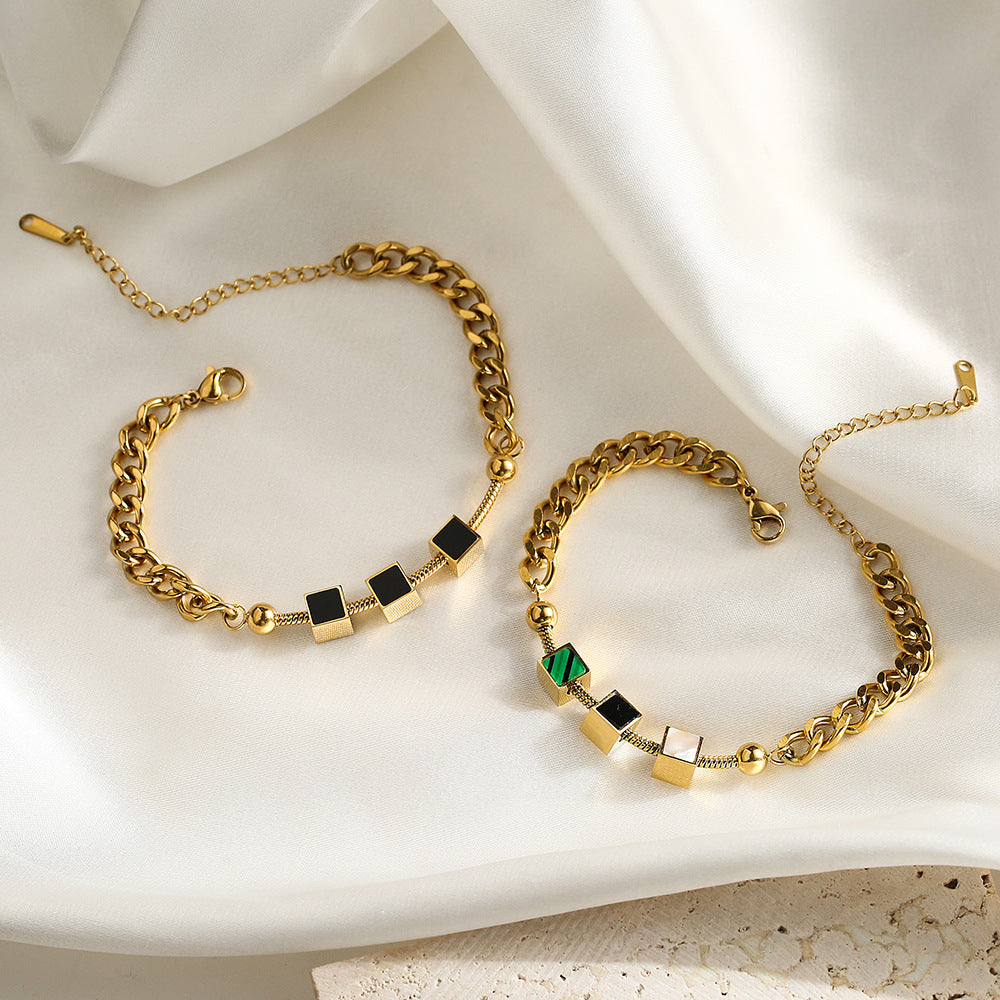 Bracciale da donna in acciaio al titanio con geometria minimalista, finitura placcata e design a catena ispirato alle conchiglie
