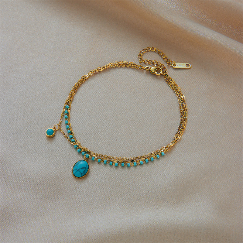 Bracciale con ciondolo ovale in turchese bohémien vintage in acciaio al titanio con finitura placcata