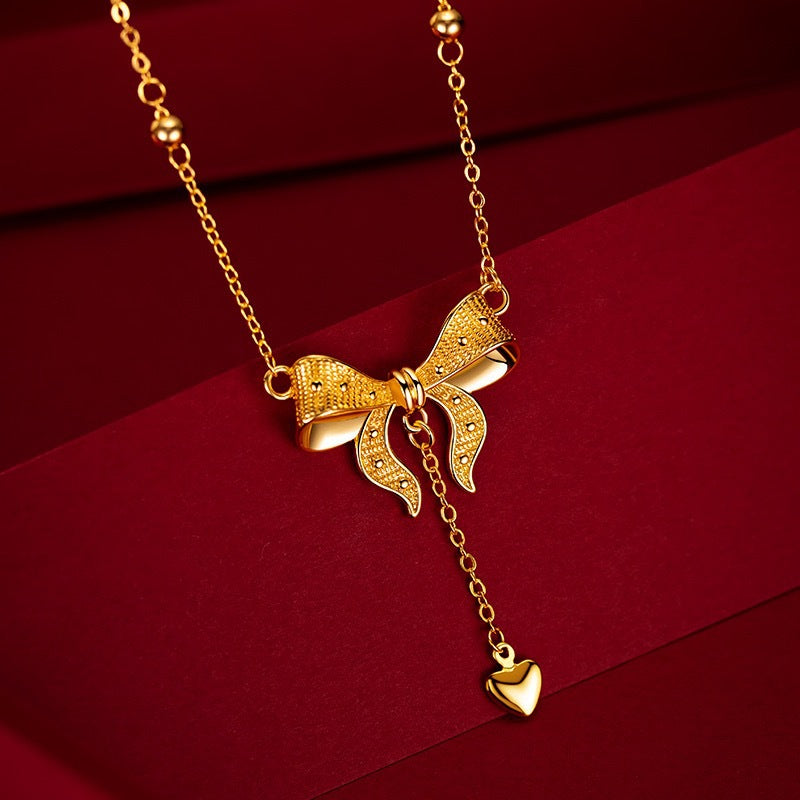 Elegante collana a clavicola in acciaio al titanio stile principessa con ciondolo a cuore, fiocchetti e dettagli a frange su catena a maglie O-ring
