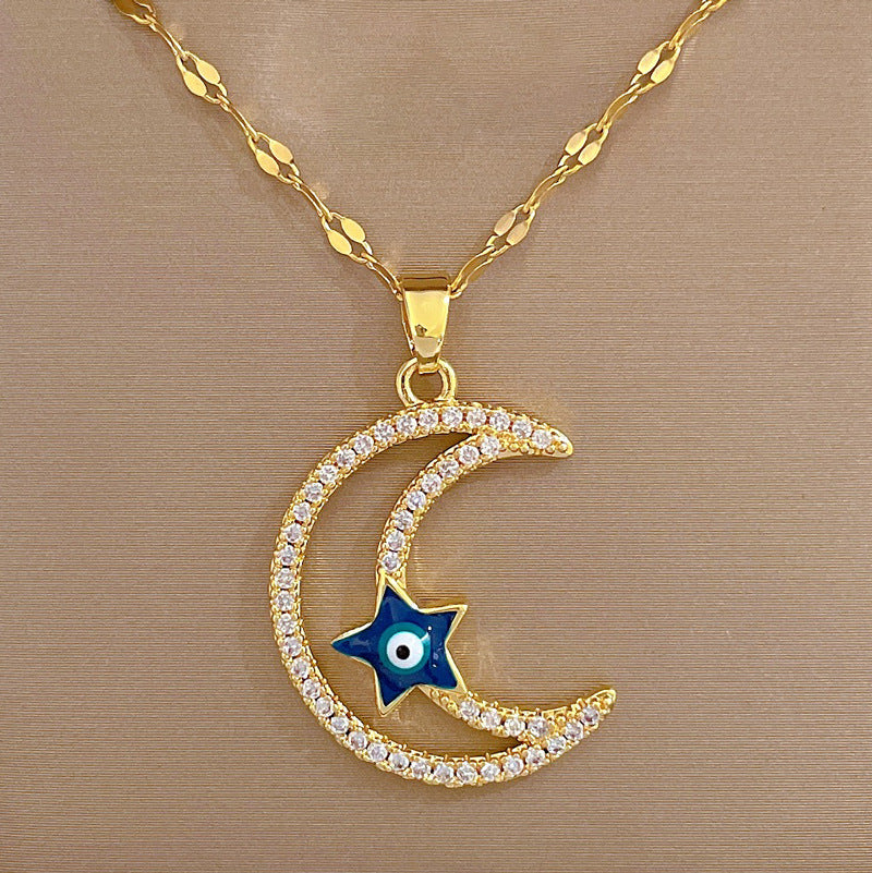 Collana con pendente minimalista a stella e luna da donna in acciaio al titanio con intarsio di strass e finitura placcata