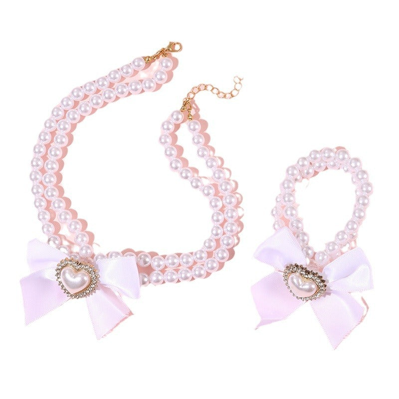 Elegante collar de perlas de doble capa para niñas con lazo y colgante de corazón en estilo estético crema, joyería de resina