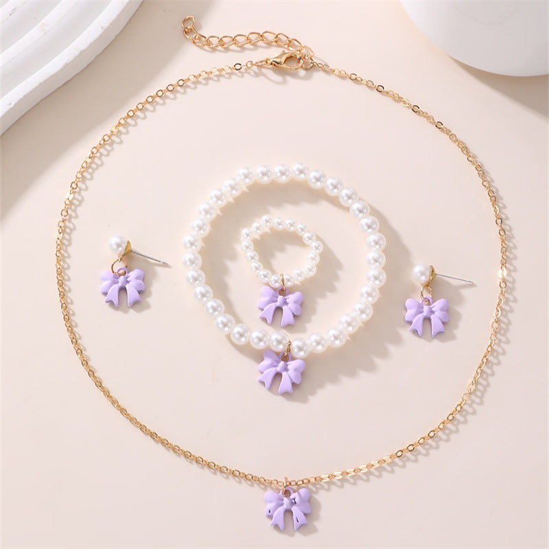 Conjunto de collar y pulsera de perlas dulces con colgante de lazo para niños en material de resina con acabado esmaltado