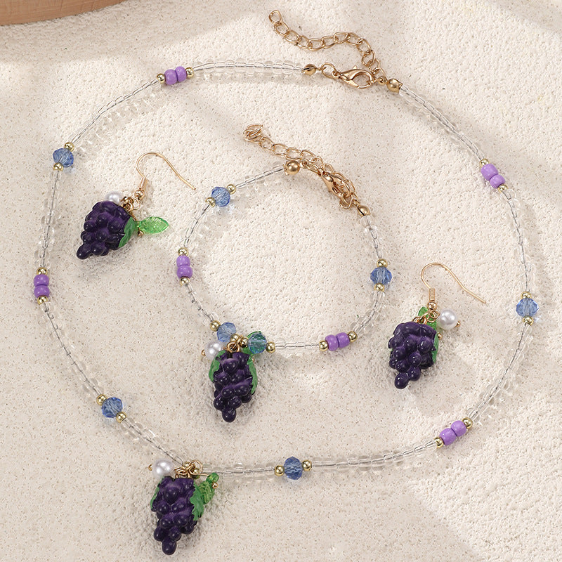 Set collana e braccialetto in lega con fiocco minimalista per ragazze con ciondoli a forma di ciliegia, uva, frutta e stella marina