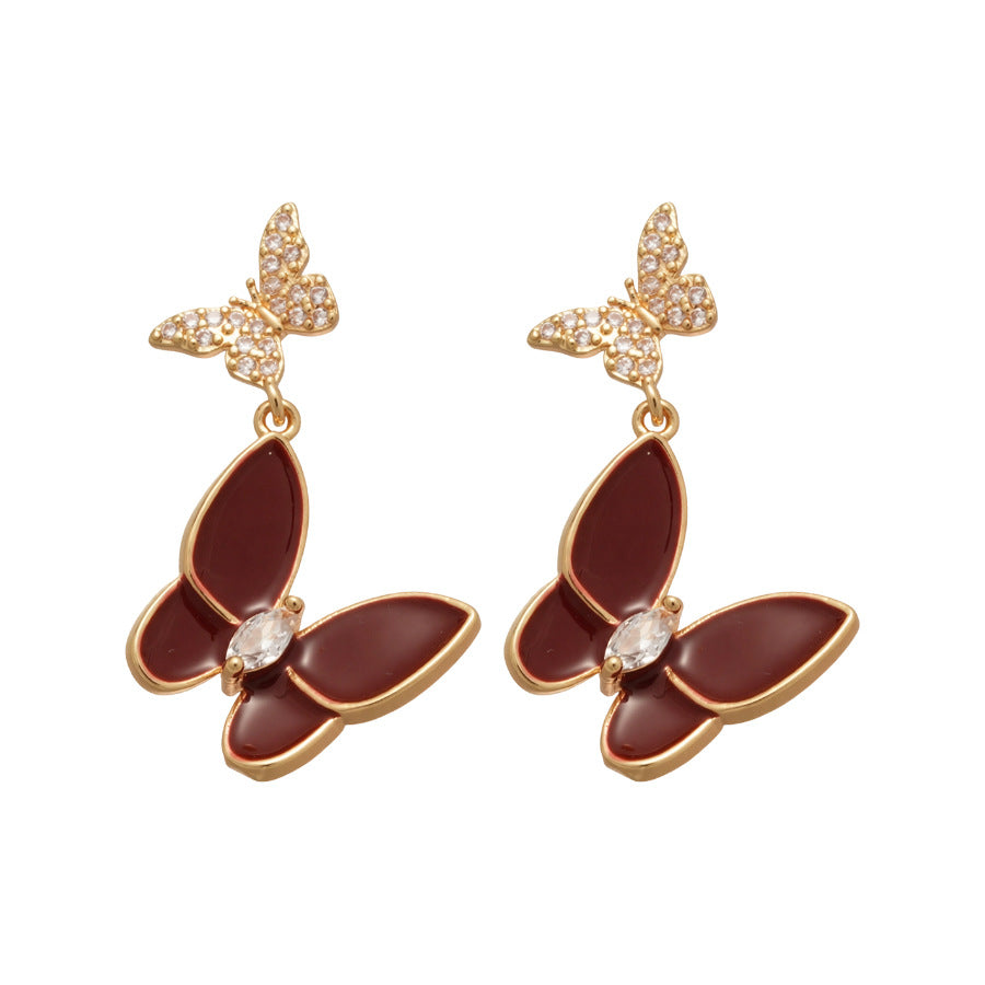 Elegantes pendientes de tuerca con forma de mariposa de estilo francés para mujer con base de cobre chapado, incrustaciones de diamantes de imitación y acabado esmaltado