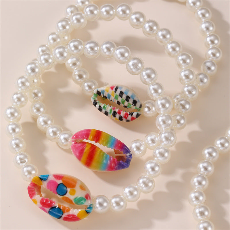 Braccialetto elastico da ragazza fatto a mano con perline in resina a forma di stella, dettagli in perle e stampa floreale