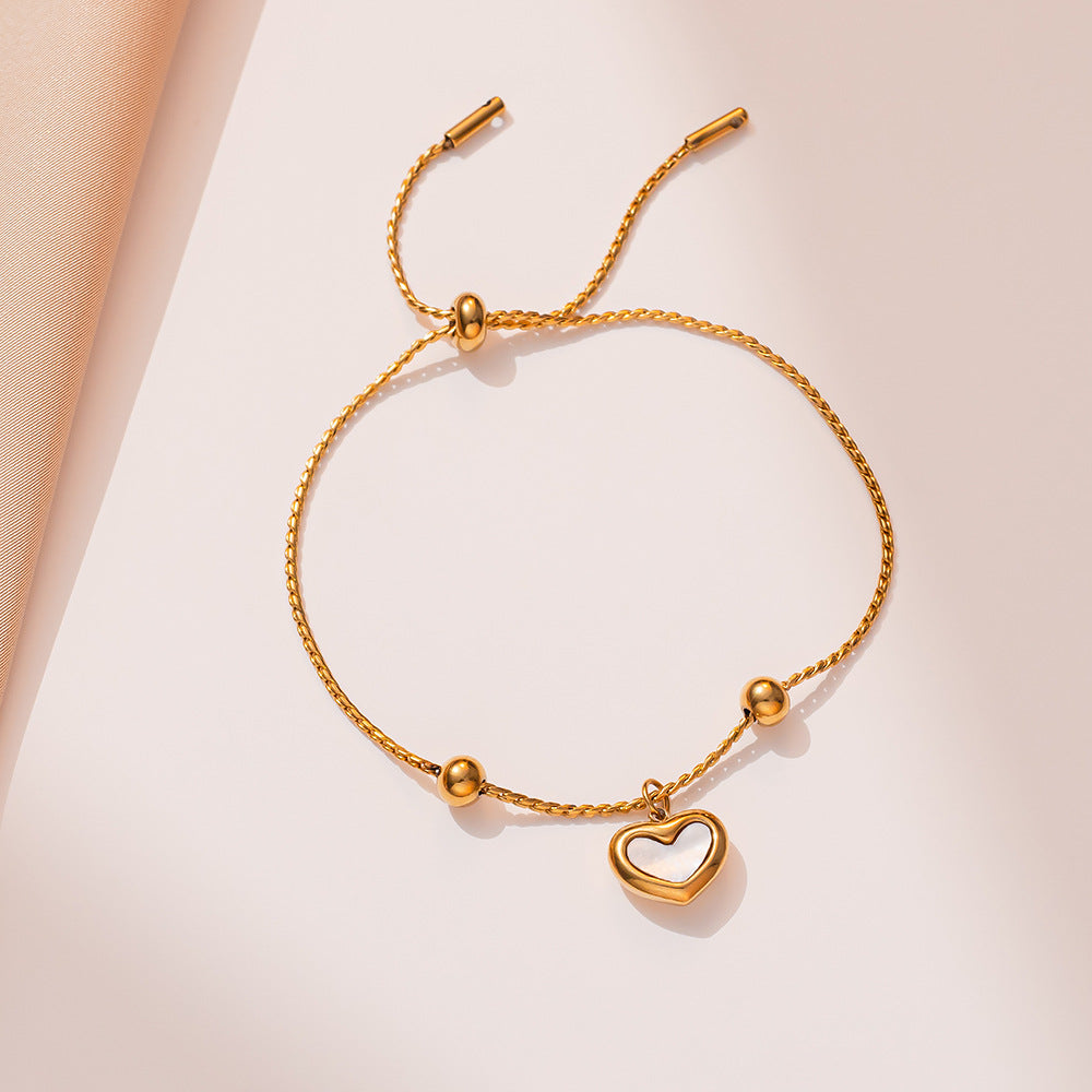 Bracciale Minimalista in Acciaio al Titanio a Forma di Cuore con Intarsio in Madreperla Bianca e Chiusura a Scorrimento da Donna