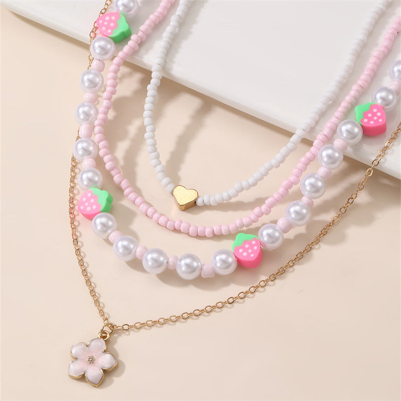 Collar con colgante de lazo y mariposa minimalista para niños, fabricado en resina con acabado esmaltado en tono rosa