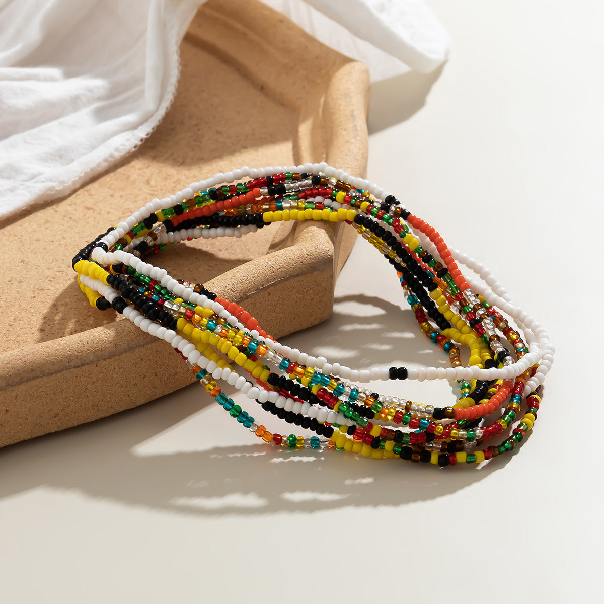 Cadena de cintura minimalista de cuentas para mujer con diseño elástico y detalle de borla en material plástico