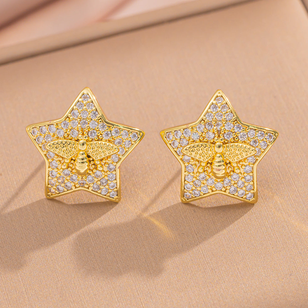 Orecchini a perno Saturno minimalisti color oro in ottone con zirconi per donna