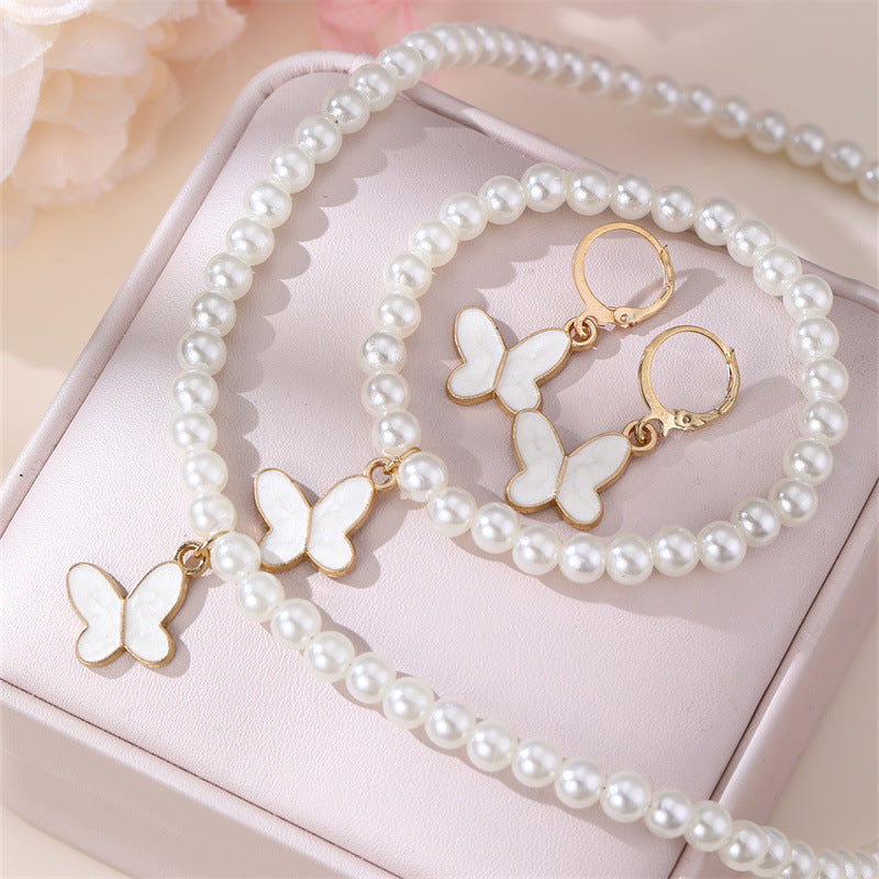 Conjunto Minimalista de Collar con Forma de Lazo de Aleación para Niñas con Detalles de Perlas, Incluye Pulsera, Anillo y Pendientes de Botón