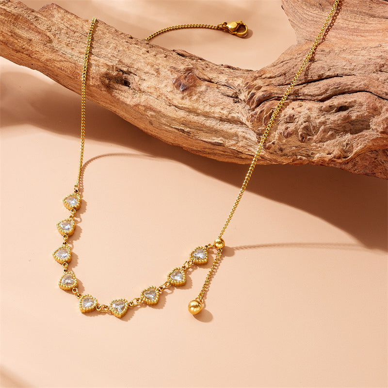 Minimalist Plated Stainless Steel Heart Pendant Necklace with Rhinestone Accents and Long Tassel Chain