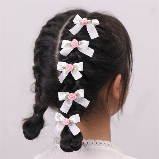 Set di fermagli per capelli per bambini a forma di fiocco in stile dolce con motivi floreali e rose in rosa e viola su sfondo a foglie verdi