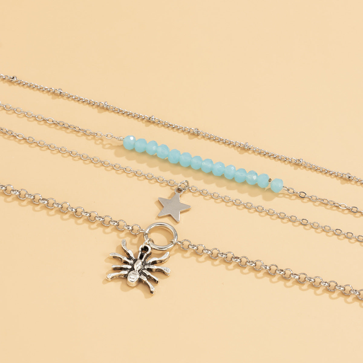 Bracciale multistrato punk "Sweet-Cool" con ragno geometrico e ciondoli a stella e croce in lega placcata