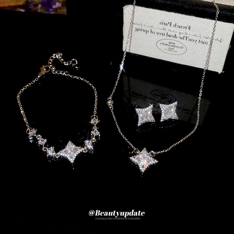 Elegante juego de collar y pulsera de cobre con forma de estrella con incrustaciones de circonita para mujer