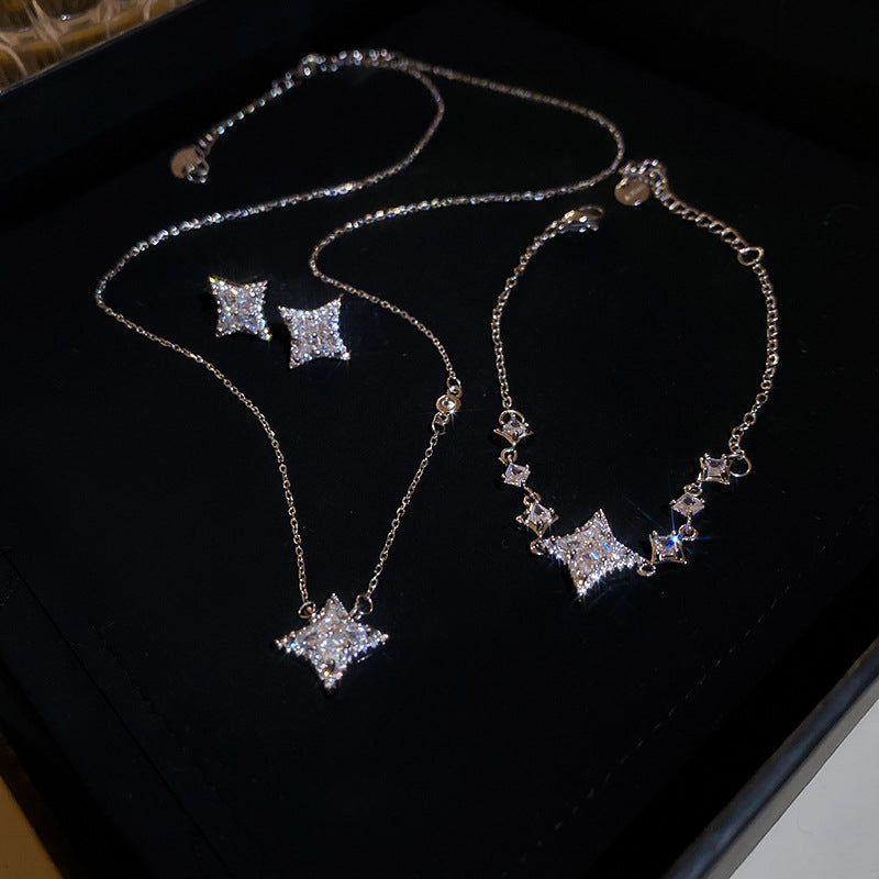 Elegante juego de collar y pulsera de cobre con forma de estrella con incrustaciones de circonita para mujer