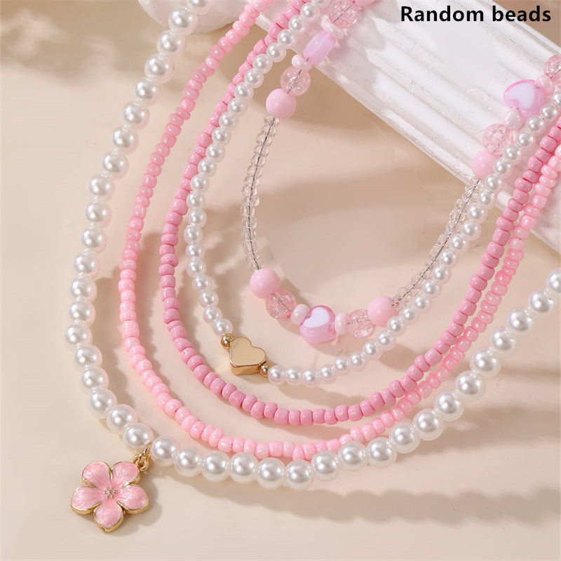 Collar Minimalista de Corazón de Concha Marina y Perla para Niñas con Dije de Resina y Acabado Pulido en Cadena de Cuentas