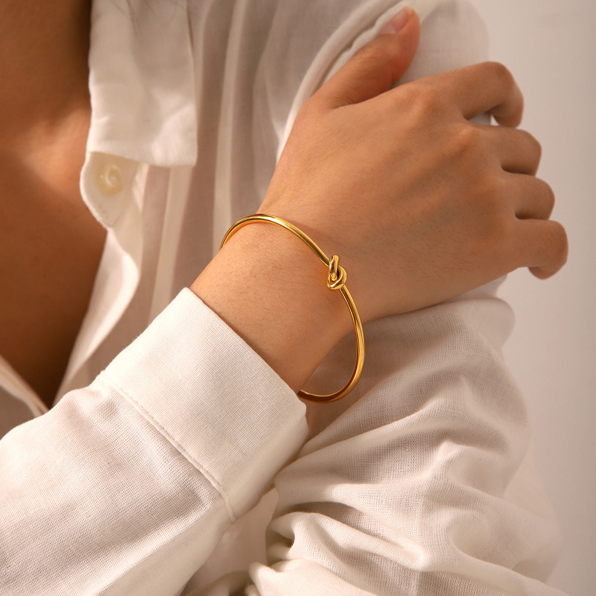 Minimalist Knot Design Stainless Steel Bracelet for Women with Plated Finish and Adjustable Open Bangle Style