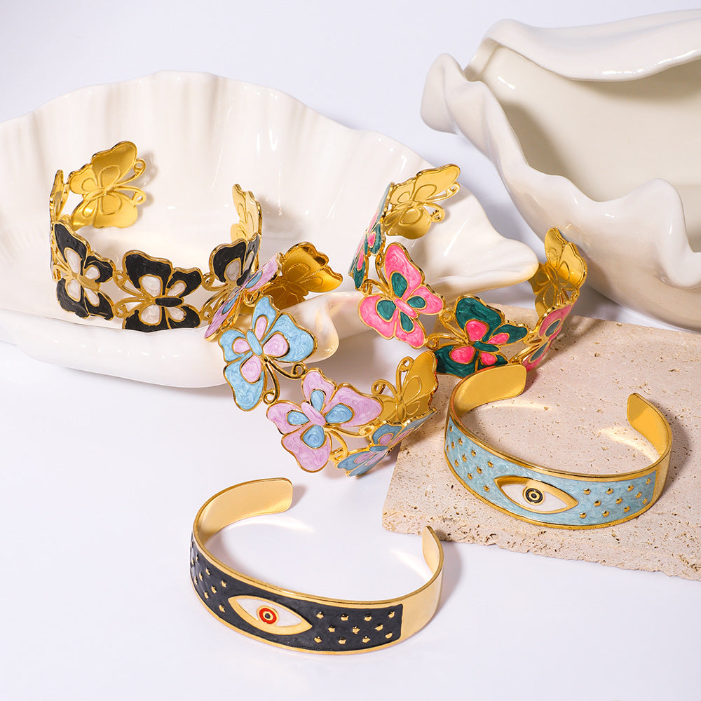 Bracciale rigido regolabile in acciaio inossidabile smaltato con placcatura in oro sottovuoto, motivo floreale geometrico e occhio di Fatima in stile vintage