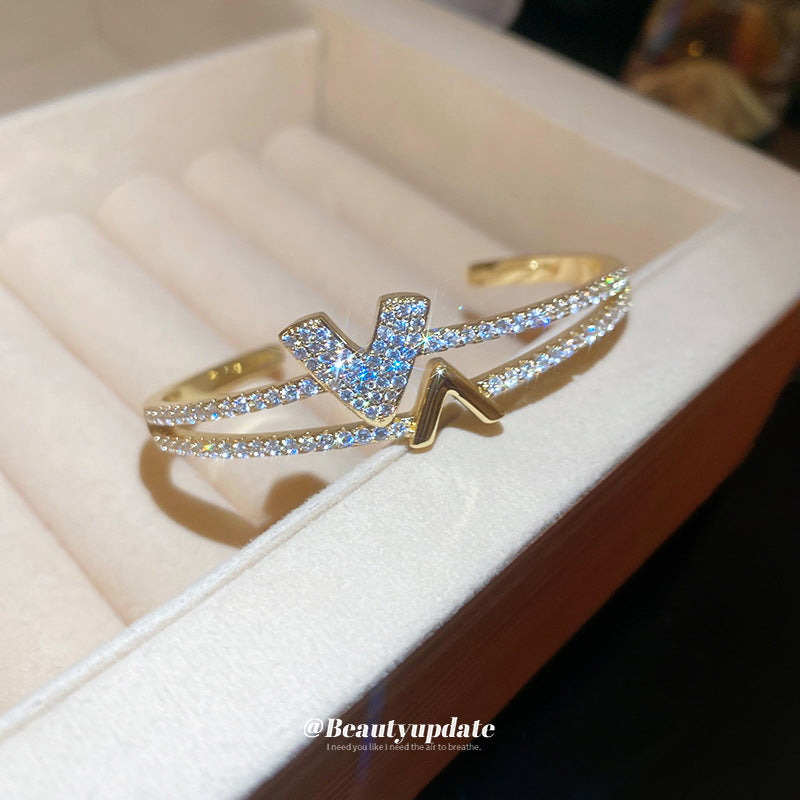 Pulsera tipo brazalete de aleación de cobre bañada en oro de lujo con incrustaciones de diamantes de imitación para mujer