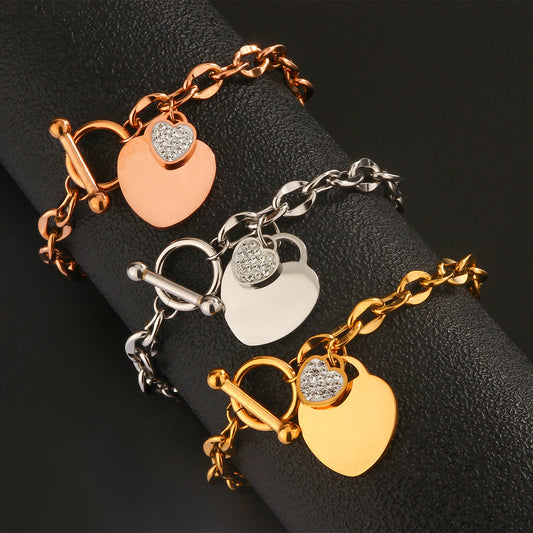 Elegante bracciale da donna a cuore in acciaio al titanio con zirconi cubici e chiusura a T