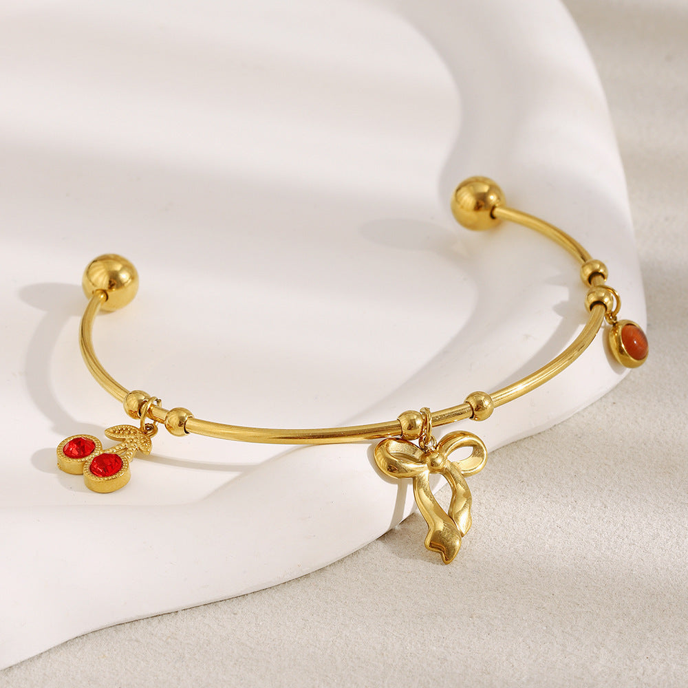 Elegant Fashionable Bowknot-Shaped Stainless Steel Plated 18K Gold C-Shaped Bracelet with Red Rhinestone Cherry Accent