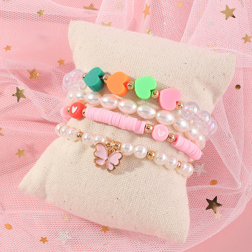 Pulsera de arcilla polimérica con mariposa y corazón esmaltados hechos a mano para niñas con detalles de perlas, bonito y versátil conjunto de joyas infantiles