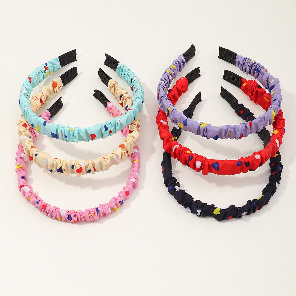 Bonita diadema de resina plástica con estampado de corazones para niños con acabado artesanal en forma geométrica