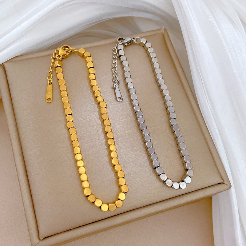Bracciale Minimalista da Donna a Catena Box in Acciaio al Titanio Tonalità Fredde con Design Zodiacale e Intarsio in Oro