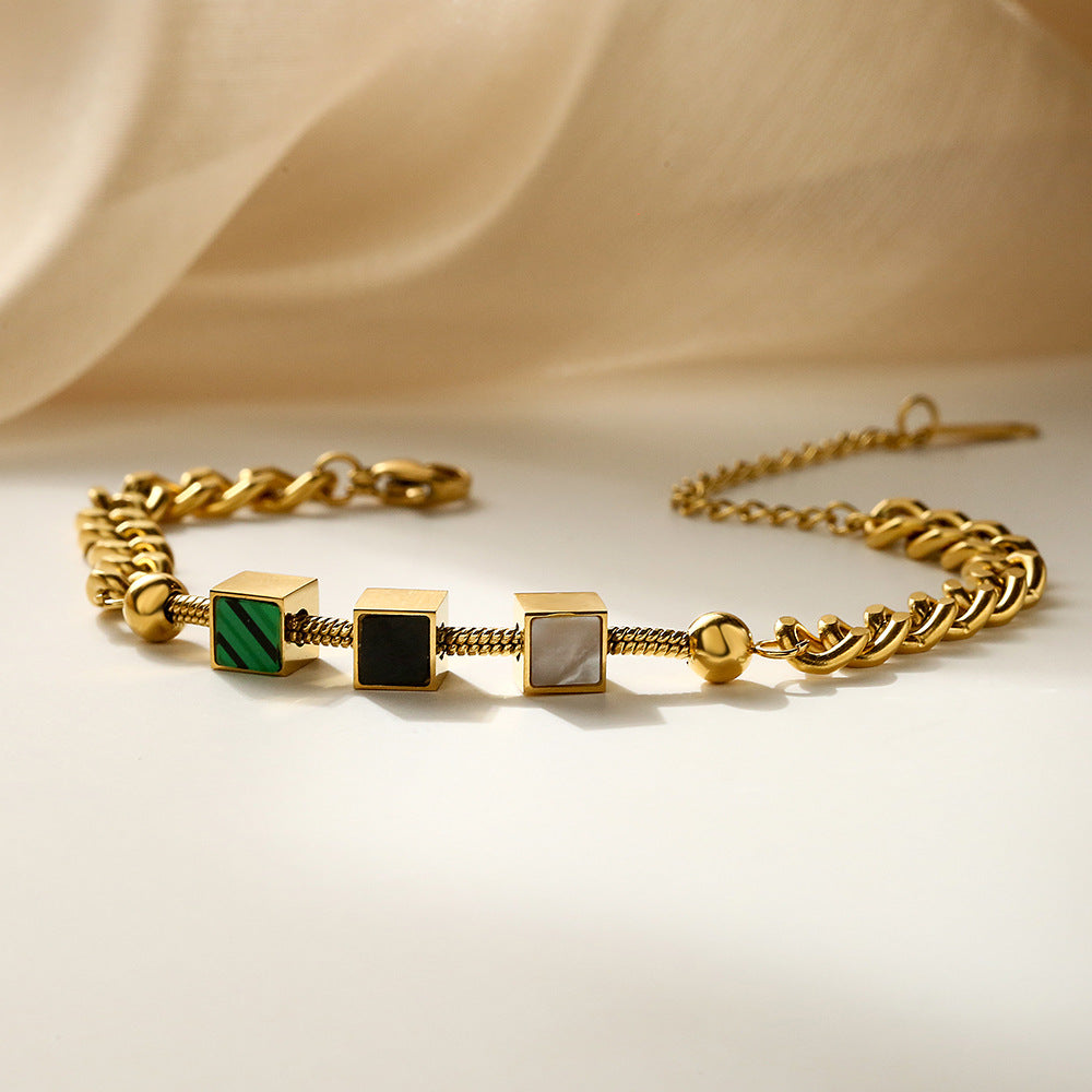Bracciale da donna in acciaio al titanio con geometria minimalista, finitura placcata e design a catena ispirato alle conchiglie