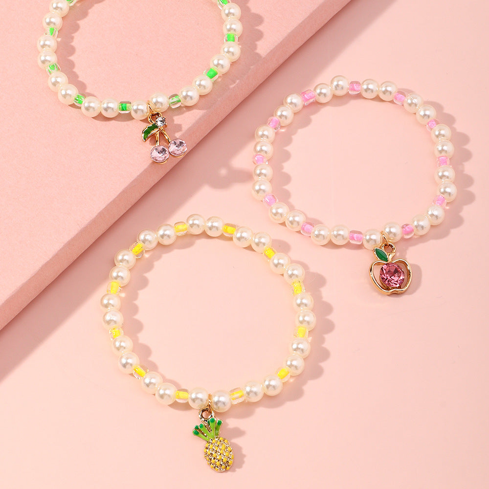 Juego de pulseras infantiles con forma de fruta estilo caricatura, con detalles de perlas y base de aleación para niñas de 6 a 10 años