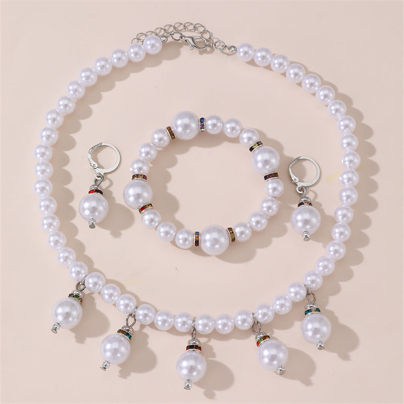 Conjunto de collar, aretes y pulsera minimalistas con perlas y lazo para niñas