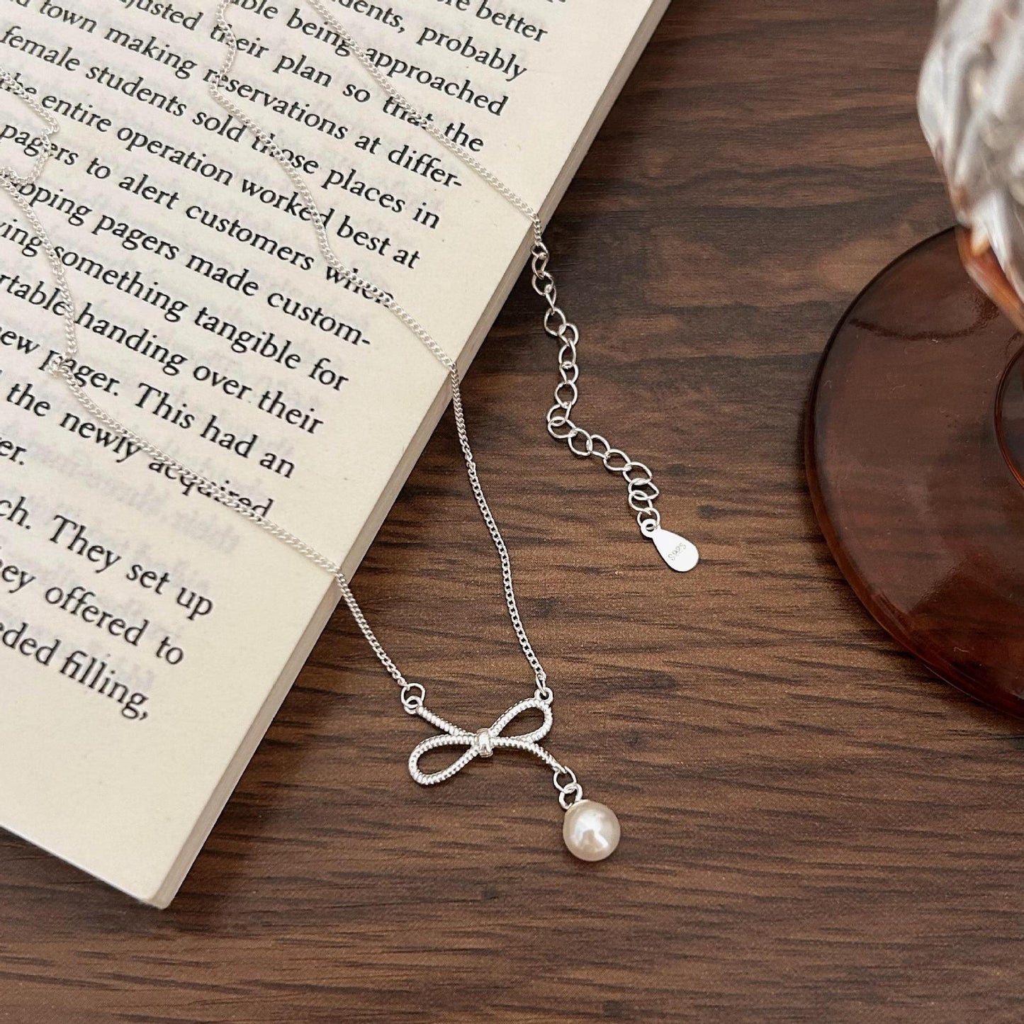 Collana minimalista a forma di fiocco in argento sterling 925 con accento di perla su catena a croce
