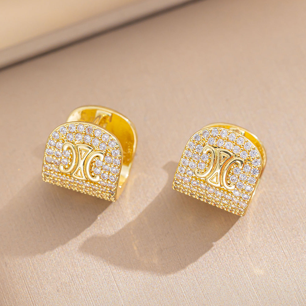 Orecchini a perno Saturno minimalisti color oro in ottone con zirconi per donna