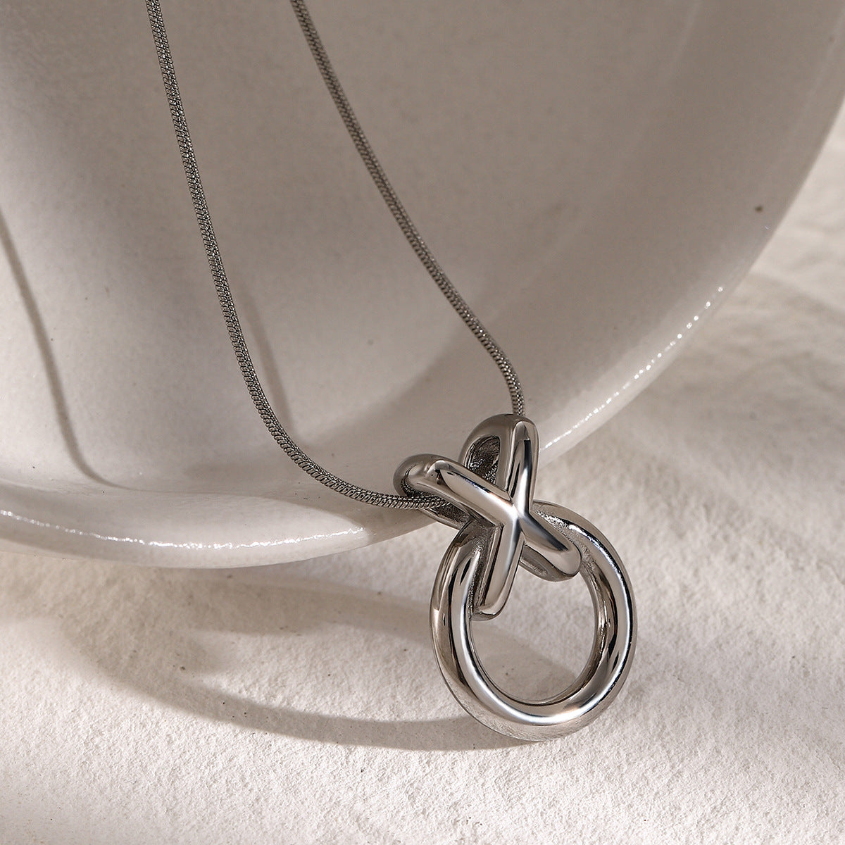 Collana girocollo minimalista in acciaio al titanio placcato oro 18K con fiocco su catena snake