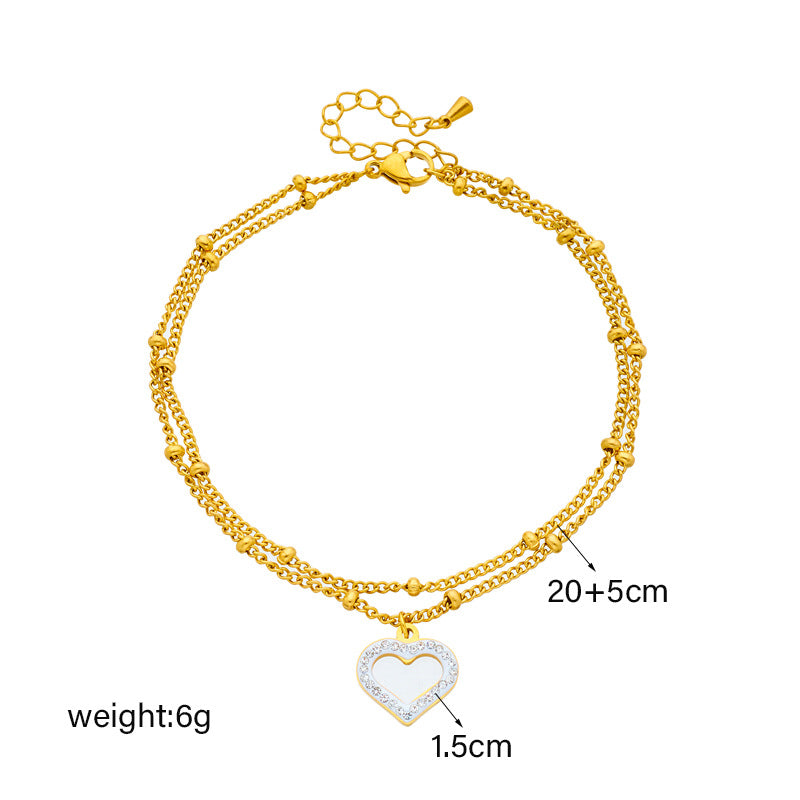 Cavigliera minimalista in acciaio al titanio a forma di cuore con intarsio di strass e design a doppia catena