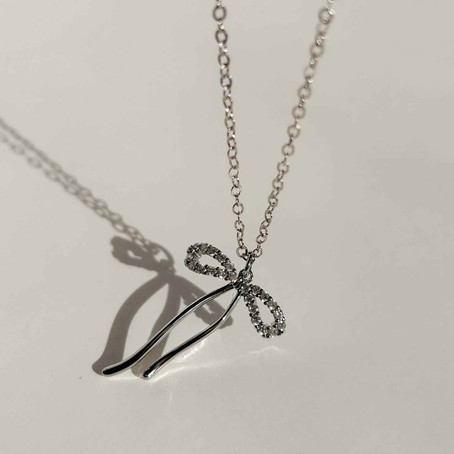 Minimalist Bow-Shaped Pendant Necklace for Women and Men with Titanium Steel Bow Charm on Snake Chain Stainless Steel Vacuum Plated Finish