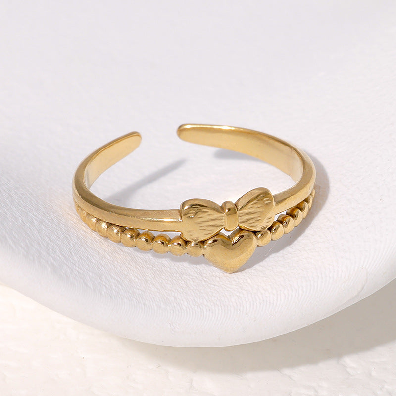 Anello regolabile da donna in acciaio inossidabile con fiocco a forma di cuore minimalista e finitura placcata